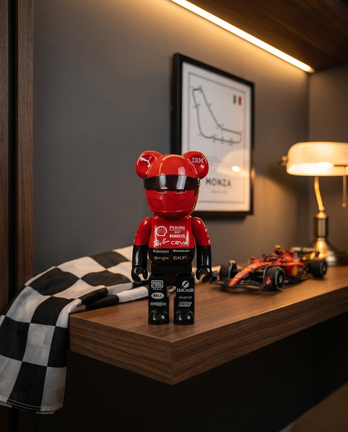 GridFig collectible on a wooden office shelf beside a chequered flag and framed circuit print