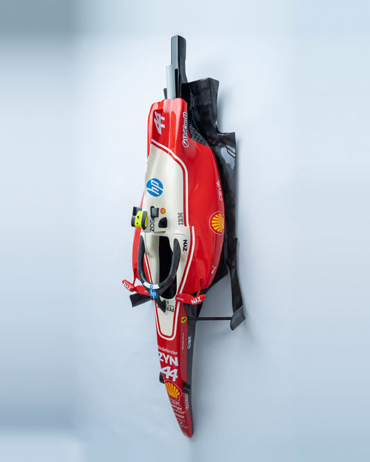 Three quarter view of the wall mounted cockpit sculpture, gloss carbon-effect side panels visible