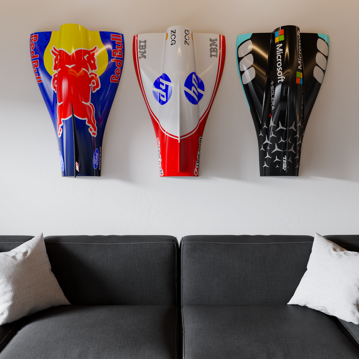Red Bull-inspired engine cover wall art at left of three above a grey sofa